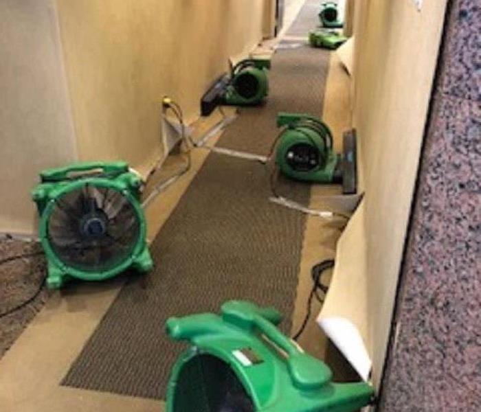 several air movers in place in a hallway