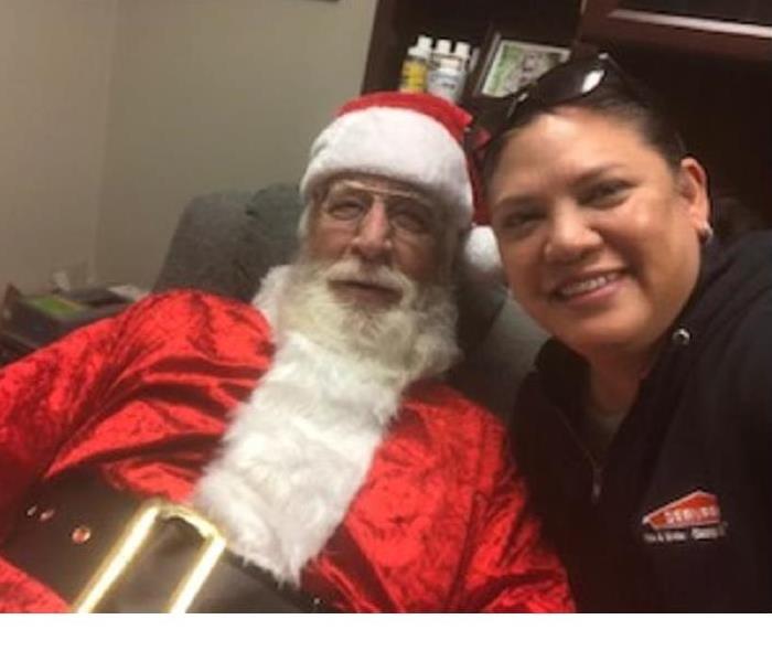 male and female employee male employee dressed like santa